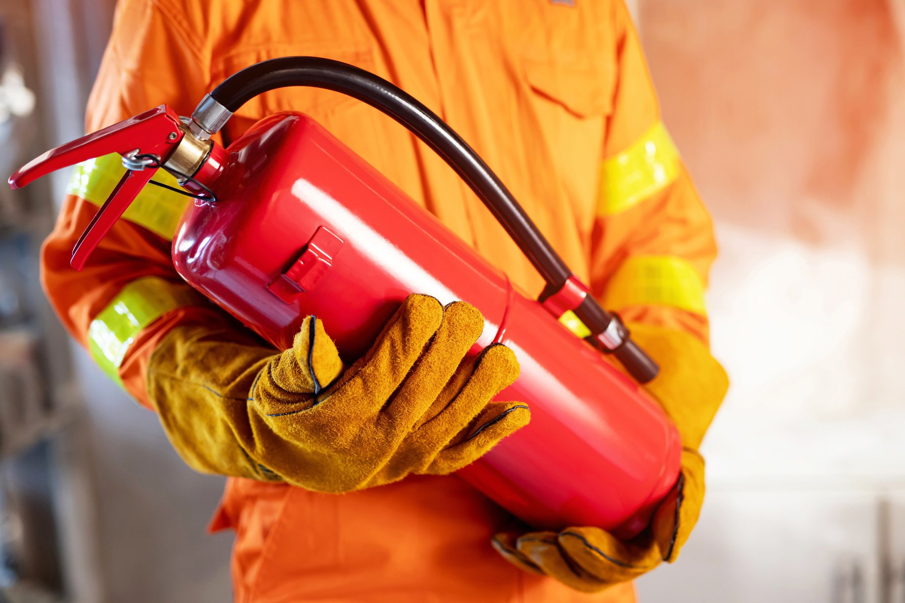 Fireman Holding Fire Extinguishers